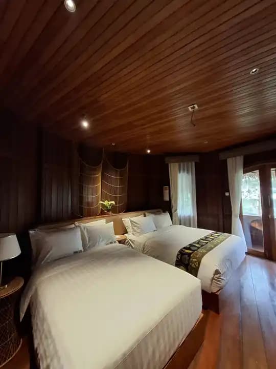 Family room with two generous beds and dark wood interiors
