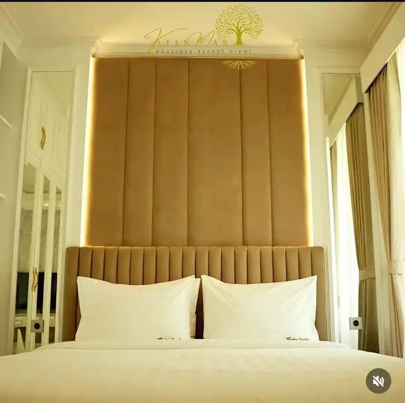 Elegant cream suite bedroom with a tall upholstered headboard